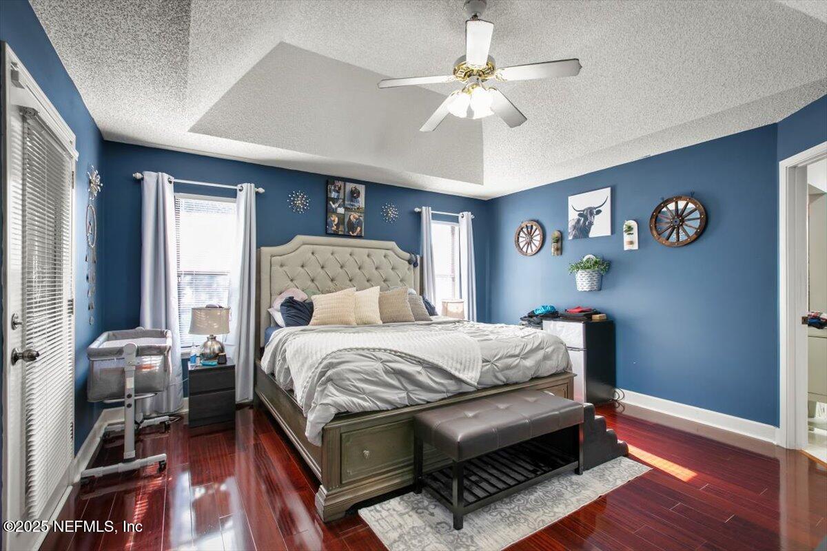 627 Whitfield Road Jacksonville, FL 32221 - Photo 11 of 18 a bedroom with a bed and a chandelier