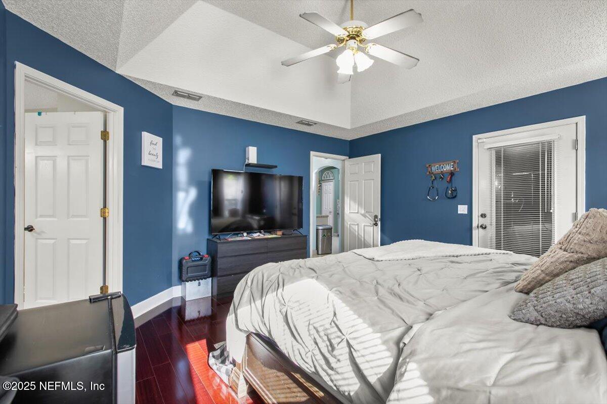 627 Whitfield Road Jacksonville, FL 32221 - Photo 12 of 18 a bedroom with a bed and a flat screen tv