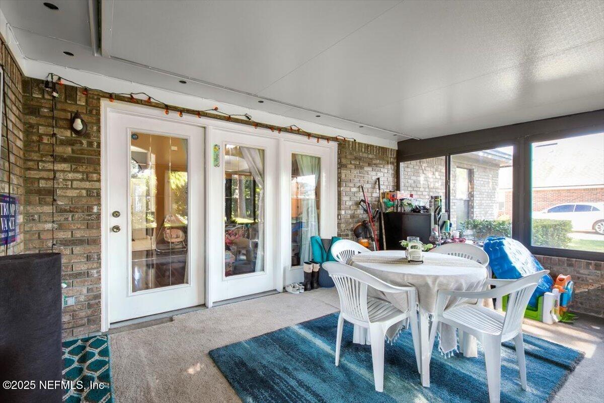 627 Whitfield Road Jacksonville, FL 32221 - Photo 15 of 18 a dining room with furniture large windows and wooden floor