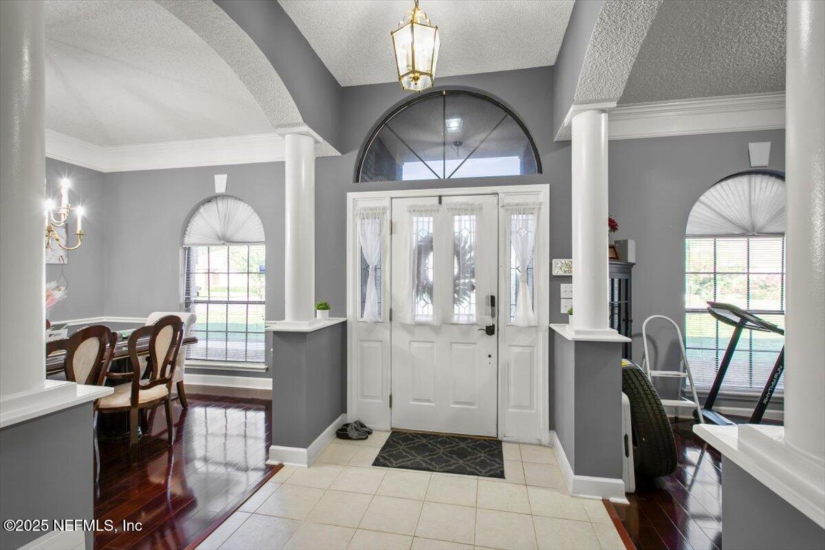 627 Whitfield Road Jacksonville, FL 32221 - Photo 3 of 18 a workspace with chandelier fan and wooden floor