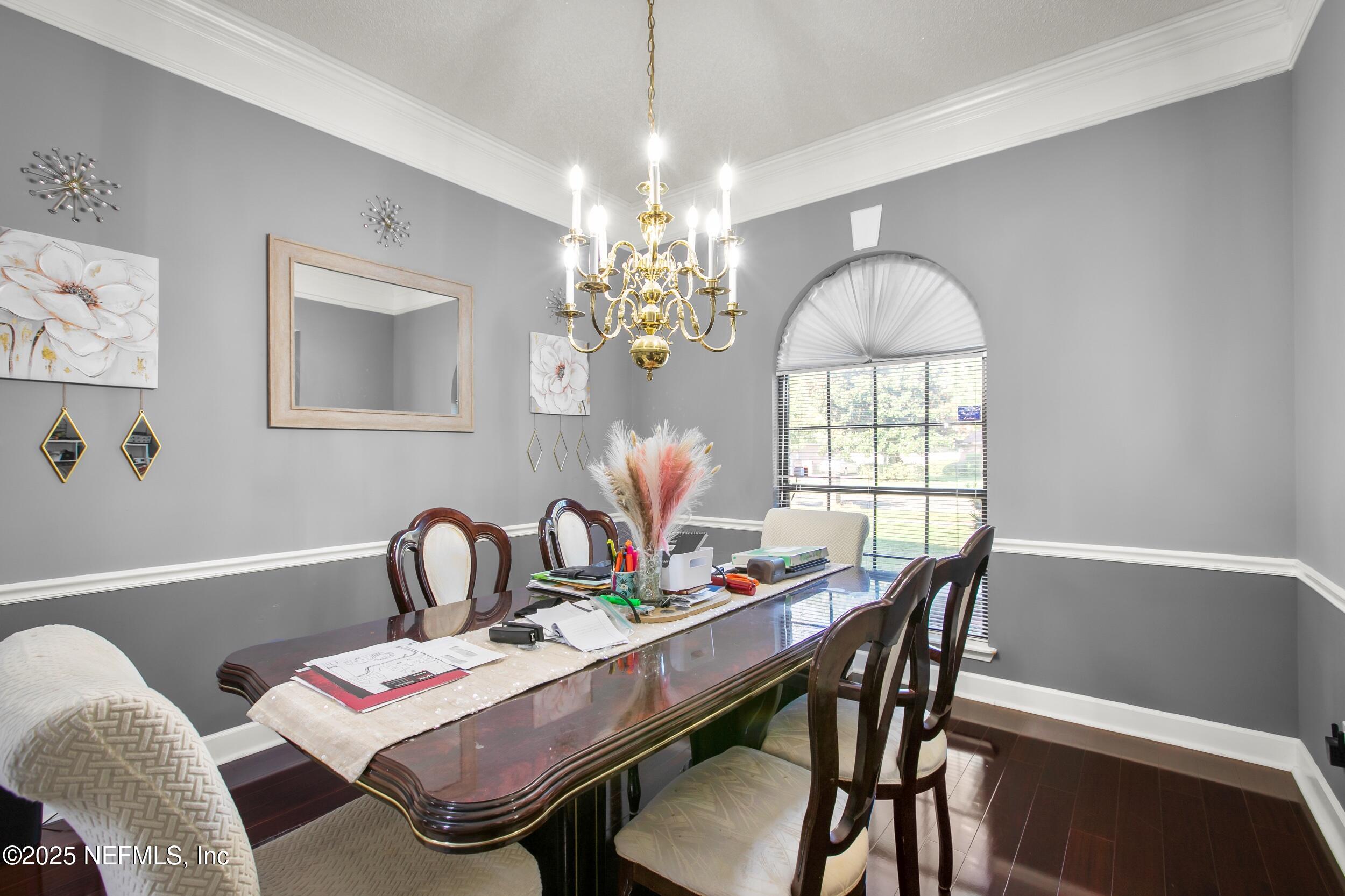 627 Whitfield Road Jacksonville, FL 32221 - Photo 4 of 18 a dining room with furniture a chandelier and window