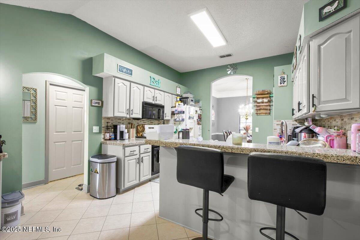 627 Whitfield Road Jacksonville, FL 32221 - Photo 6 of 18 a kitchen with stainless steel appliances kitchen island granite countertop a sink and cabinets