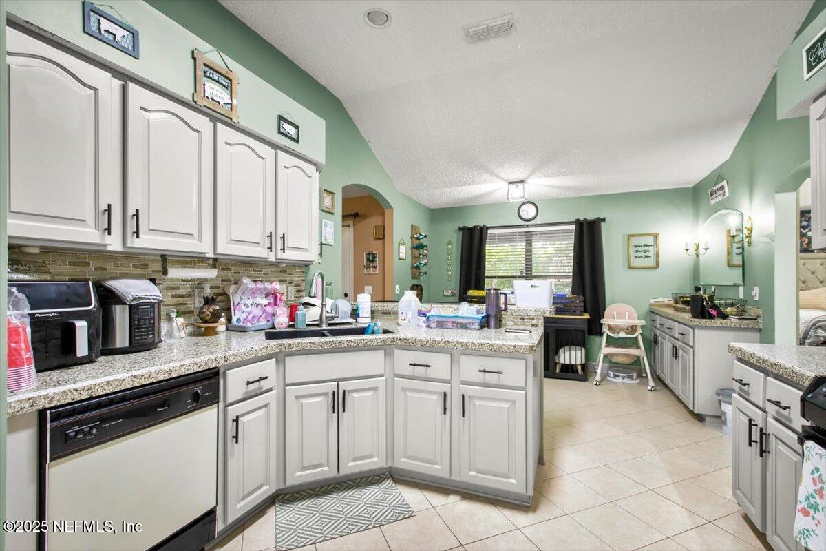 627 Whitfield Road Jacksonville, FL 32221 - Photo 8 of 18 a kitchen with stainless steel appliances granite countertop a sink and cabinets