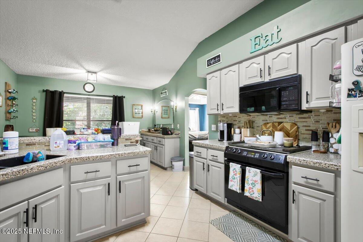 627 Whitfield Road Jacksonville, FL 32221 - Photo 9 of 18 a kitchen with stainless steel appliances granite countertop a sink and cabinets