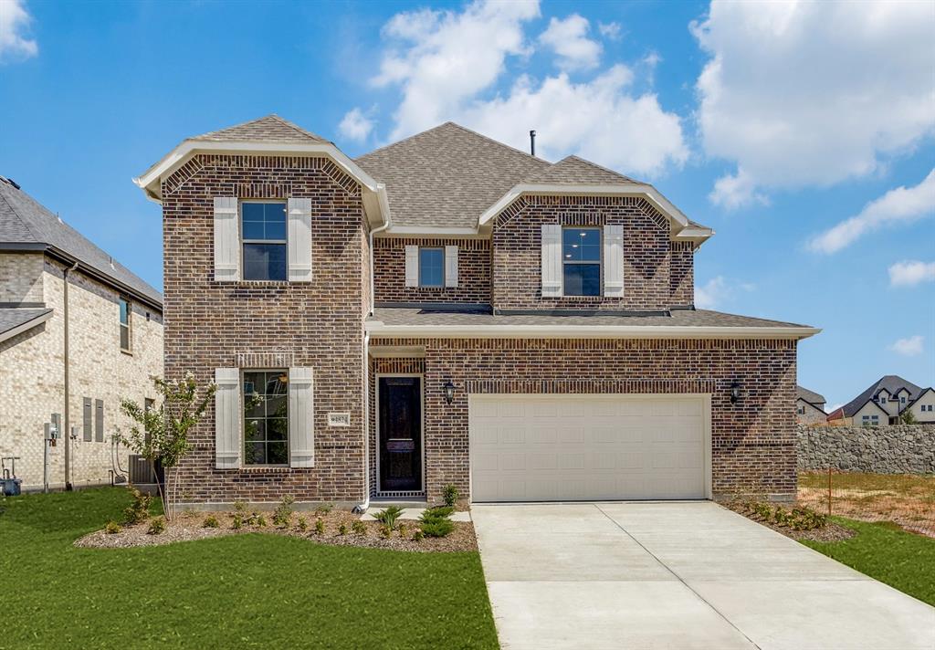 a front view of a house with a garden and plants