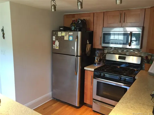 a kitchen with a stove and a refrigerator