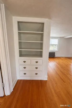 a living room with furniture a rug and a bookshelf