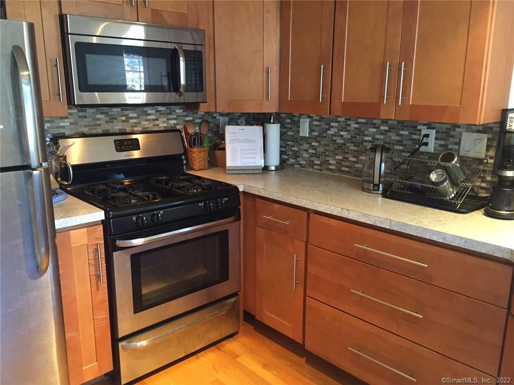 209 Willard Street, Unit 3 New Haven, CT 06515 - Photo 13 of 29 a kitchen with granite countertop a stove and a microwave