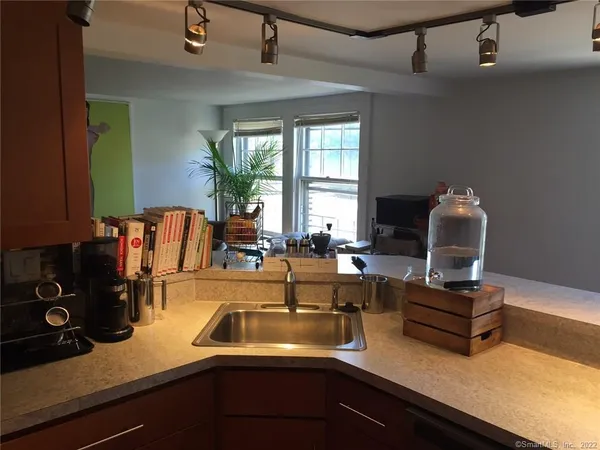 a view of a kitchen with a sink and cabinet