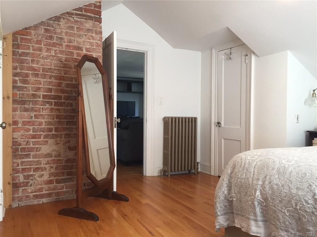 209 Willard Street, Unit 3 New Haven, CT 06515 - Photo 22 of 29 a view of a livingroom with wooden floor and a hallway