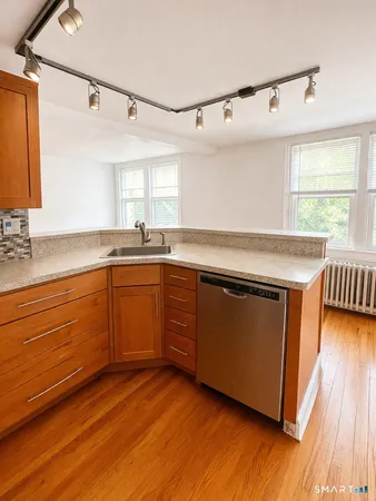 a kitchen with wooden floors and sink
