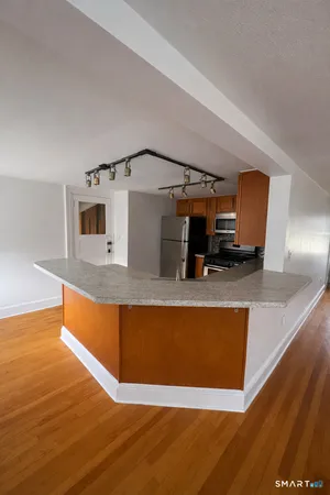 a kitchen with stainless steel appliances granite countertop a refrigerator and a stove top oven
