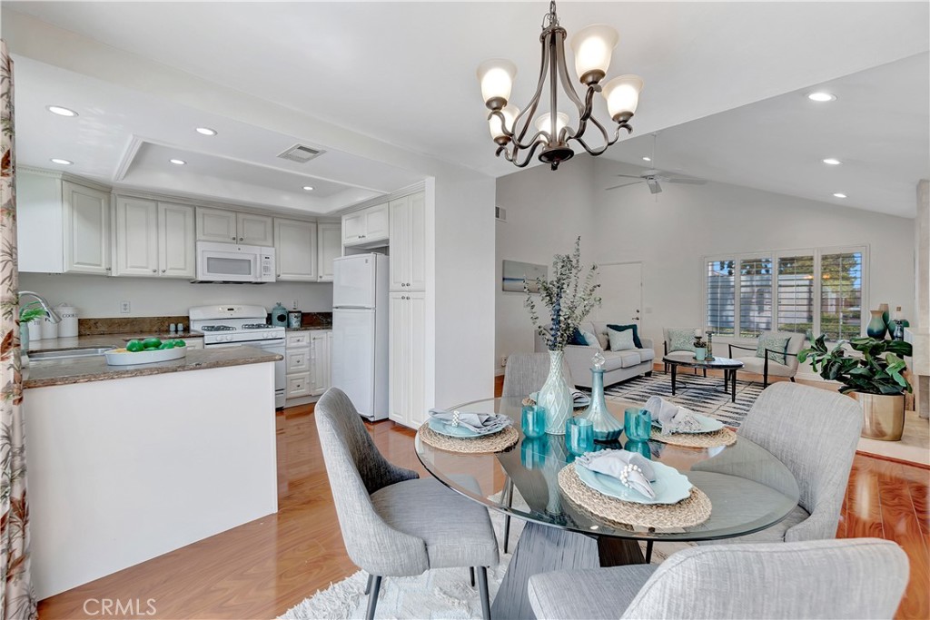 30 Silverwood Irvine, CA 92604 - Photo 11 of 32 a kitchen with a dining table and chairs