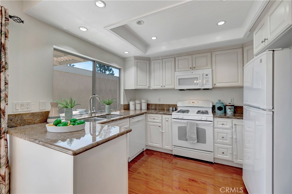 30 Silverwood Irvine, CA 92604 - Photo 13 of 32 a kitchen with stainless steel appliances granite countertop a stove a sink and a refrigerator