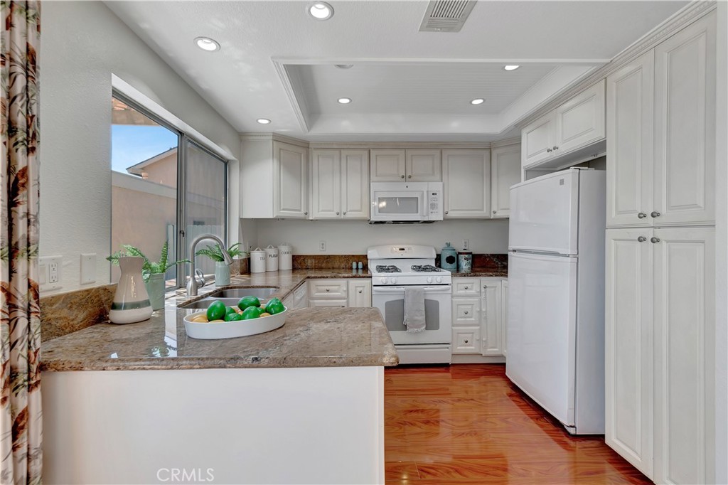 30 Silverwood Irvine, CA 92604 - Photo 14 of 32 a kitchen with stainless steel appliances granite countertop a refrigerator and a stove top oven