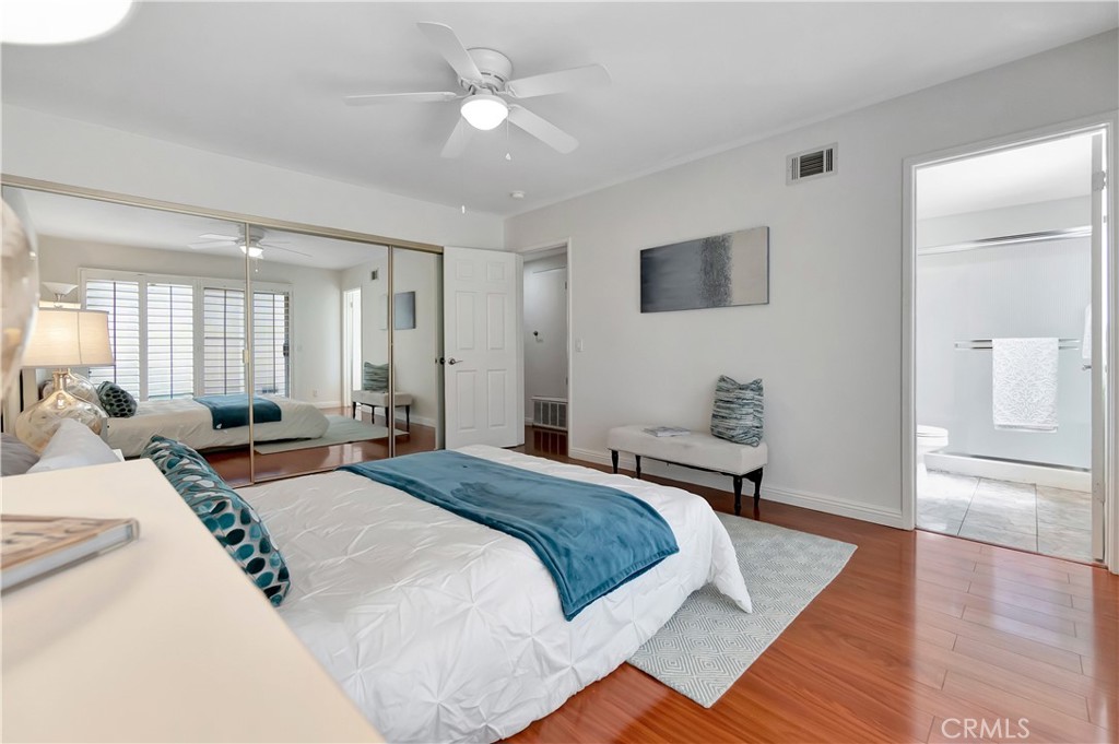 30 Silverwood Irvine, CA 92604 - Photo 17 of 32 a bedroom with a large bed and a chandelier