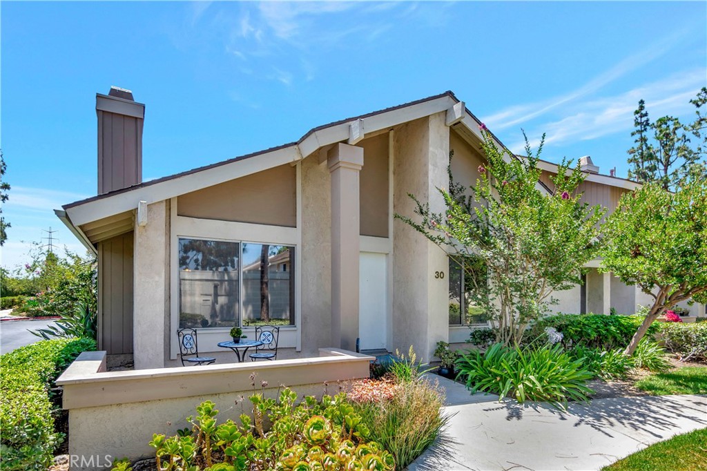 30 Silverwood Irvine, CA 92604 - Photo 2 of 32 a view of a house with potted plants and palm trees