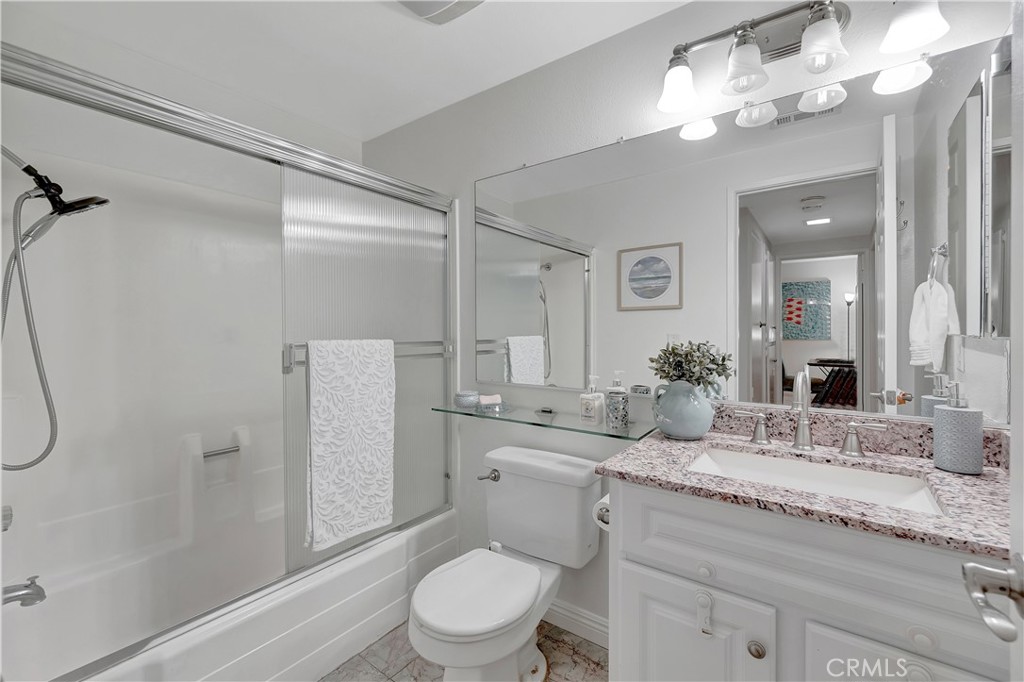 30 Silverwood Irvine, CA 92604 - Photo 22 of 32 a bathroom with a granite countertop sink a toilet and a mirror