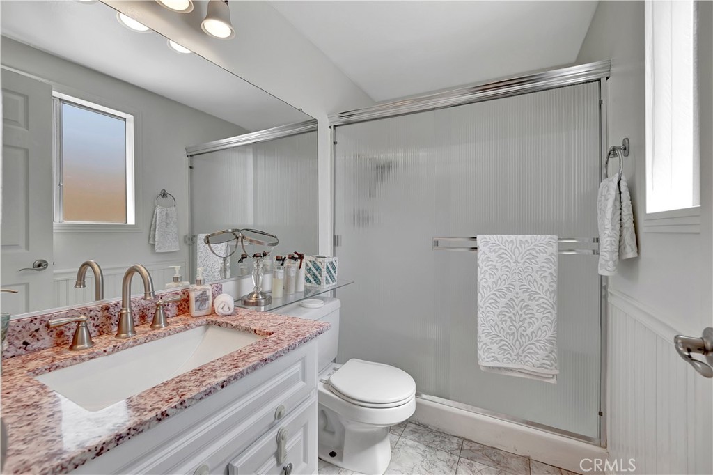 30 Silverwood Irvine, CA 92604 - Photo 23 of 32 a bathroom with a granite countertop sink toilet and shower