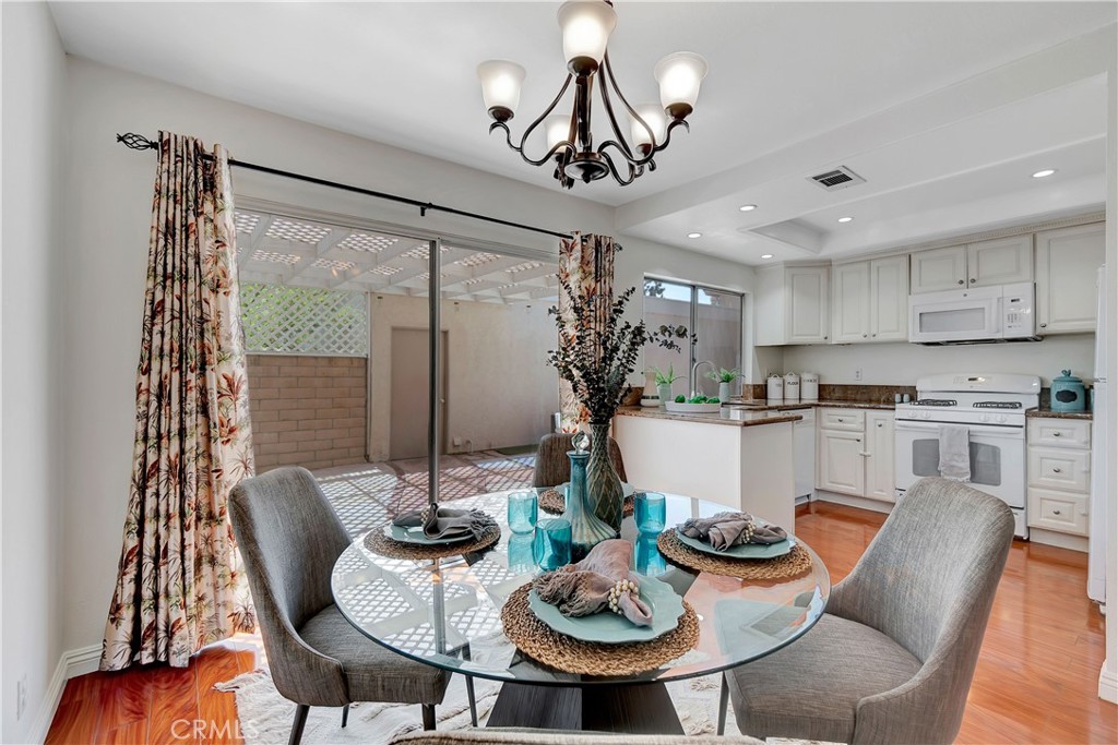 30 Silverwood Irvine, CA 92604 - Photo 10 of 32 a view of a dining room with furniture window and wooden floor
