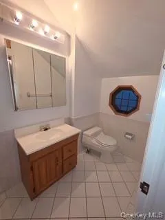 a bathroom with a sink a toilet and mirror