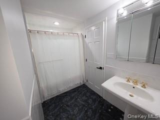 12-14 West 5th Road Queens, NY 11693 - Photo 27 of 43 a bathroom with a sink and shower