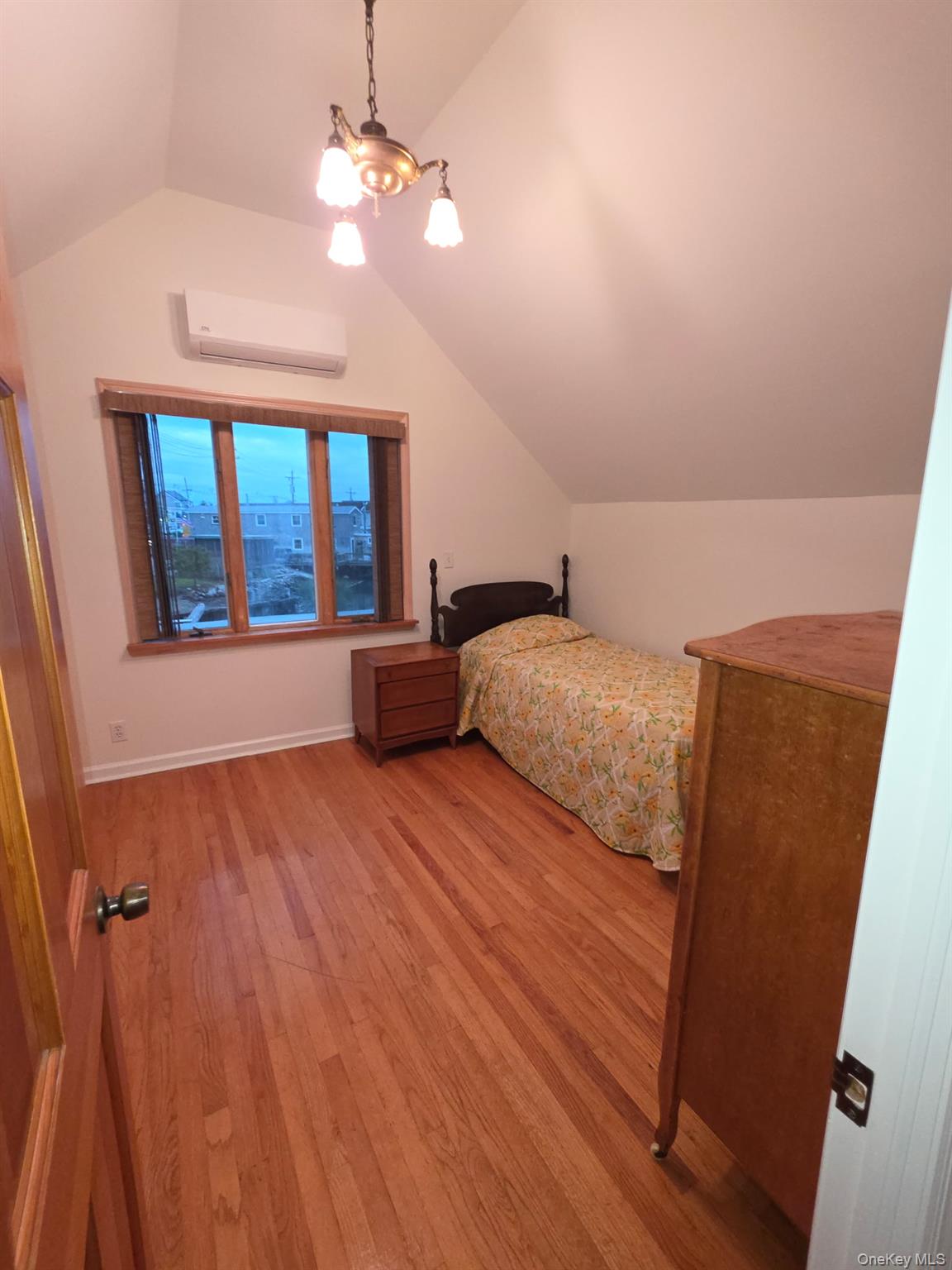 12-14 West 5th Road Queens, NY 11693 - Photo 3 of 43 a bedroom with a bed and a chandelier