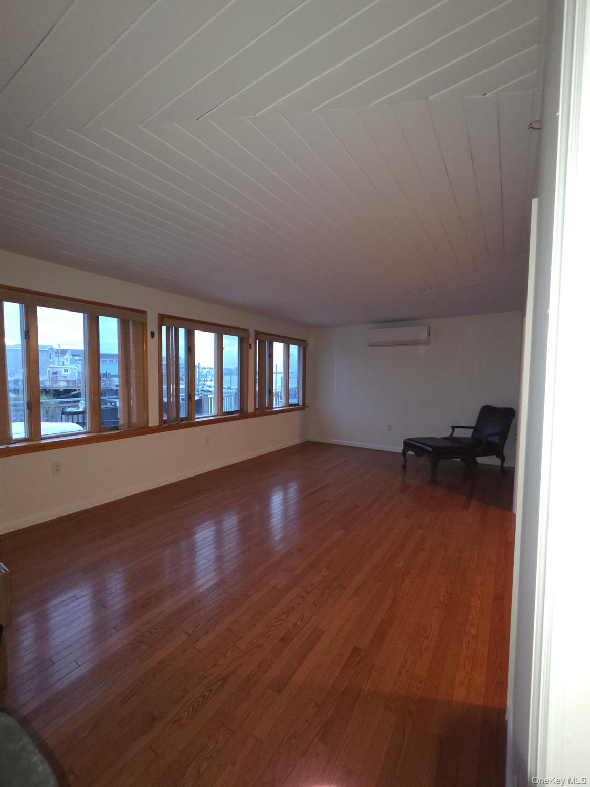 12-14 West 5th Road Queens, NY 11693 - Photo 6 of 43 wooden floor in an empty room with a window