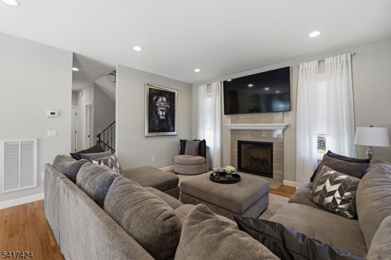 68 Arch Street Butler, NJ 07405 - Photo 14 of 46 a living room with furniture and a fireplace