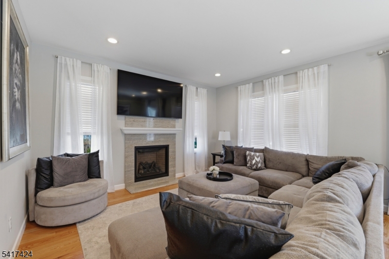 68 Arch Street Butler, NJ 07405 - Photo 15 of 46 a living room with furniture a flat screen tv and a fireplace