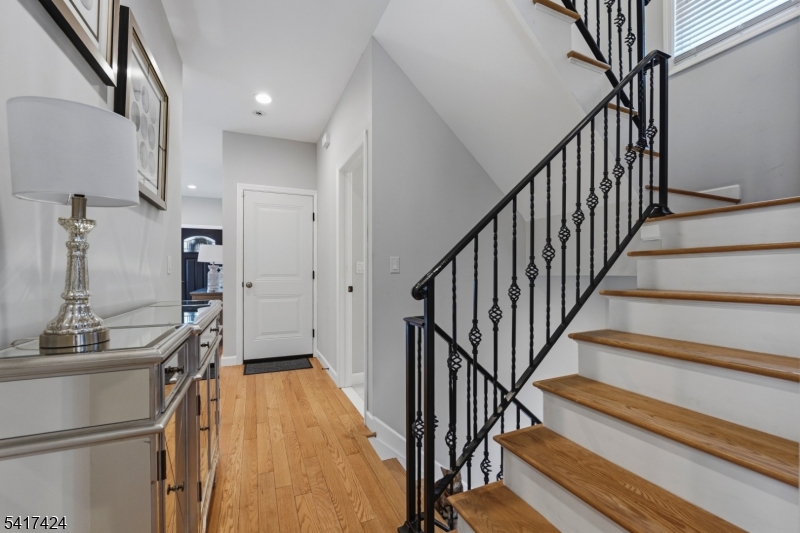 68 Arch Street Butler, NJ 07405 - Photo 18 of 46 a view of staircase with wooden floor and a chandelier