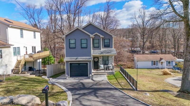 68 Arch Street Butler, NJ 07405 - Photo 2 of 46 a front view of a house with garden