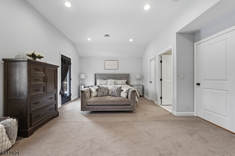 68 Arch Street Butler, NJ 07405 - Photo 22 of 46 a spacious bedroom with a bed and walk in closet