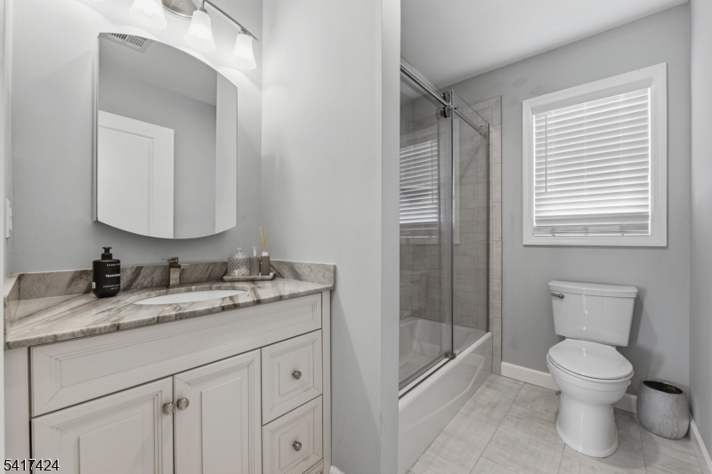 68 Arch Street Butler, NJ 07405 - Photo 30 of 46 a bathroom with a granite countertop toilet sink and mirror