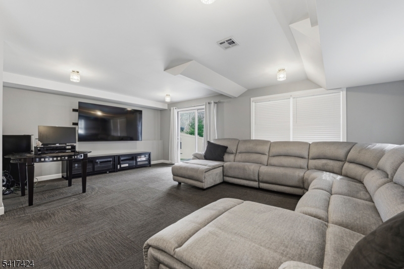68 Arch Street Butler, NJ 07405 - Photo 35 of 46 a living room with furniture and a flat screen tv