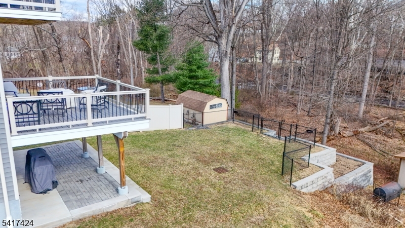 68 Arch Street Butler, NJ 07405 - Photo 39 of 46 a view of a swimming pool with a patio and wooden fence