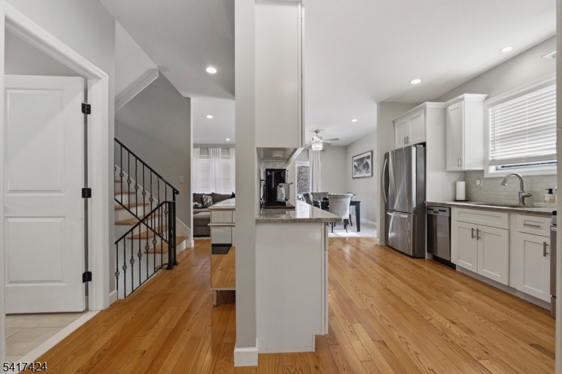 68 Arch Street Butler, NJ 07405 - Photo 6 of 46 a kitchen with stainless steel appliances a refrigerator sink and cabinets