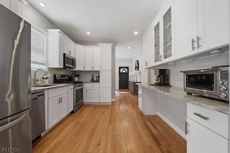 68 Arch Street Butler, NJ 07405 - Photo 9 of 46 a kitchen with kitchen island granite countertop stainless steel appliances cabinets a sink and a counter top space