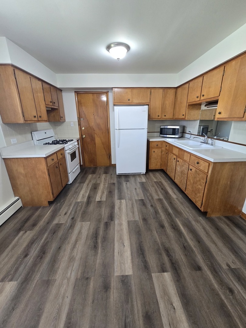 517 Bethel Drive, Unit 2S Joliet, IL 60435 - Photo 16 of 18 a kitchen with stainless steel appliances granite countertop a stove a sink and a refrigerator