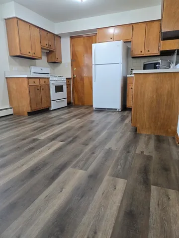 a kitchen with stainless steel appliances granite countertop a refrigerator sink and cabinets