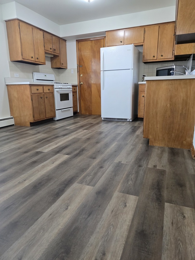 517 Bethel Drive, Unit 2S Joliet, IL 60435 - Photo 5 of 18 a kitchen with stainless steel appliances granite countertop a refrigerator sink and cabinets