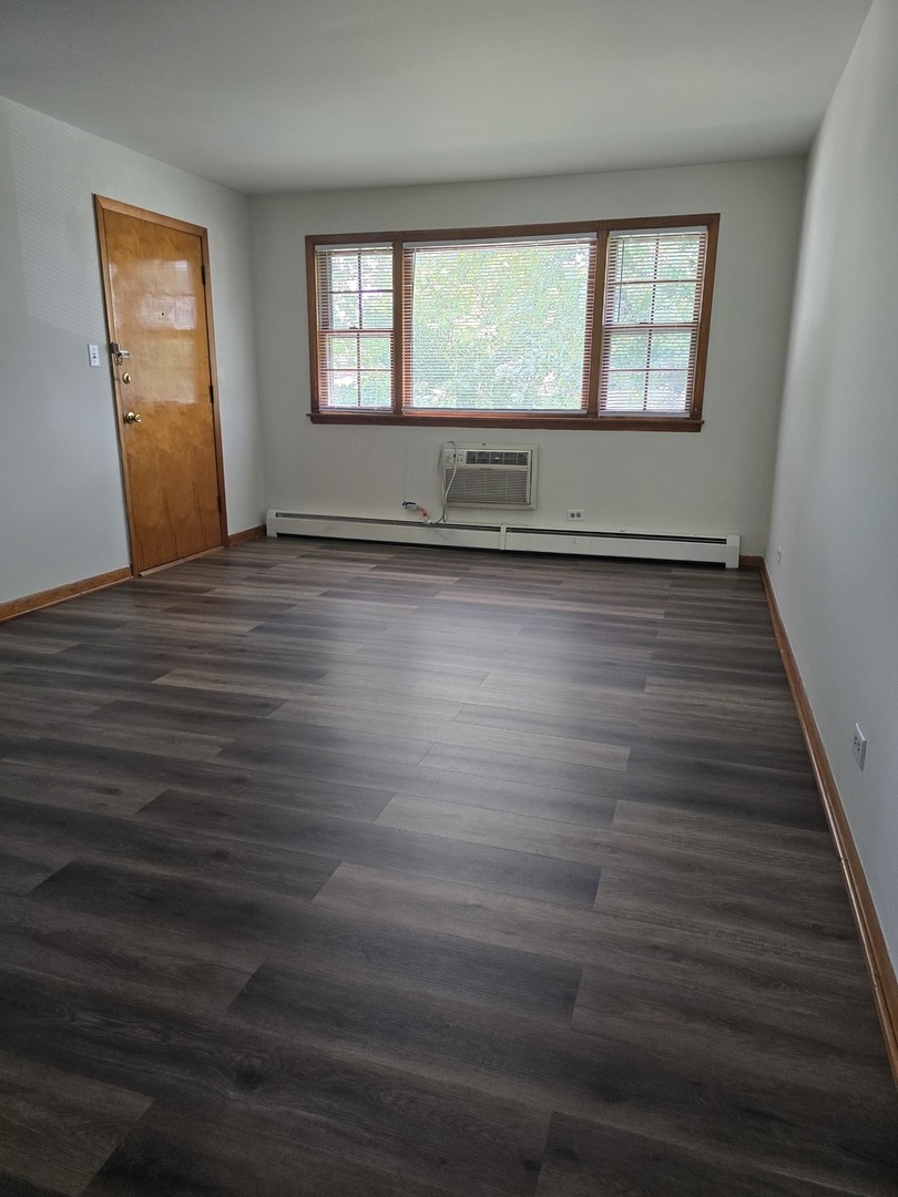 517 Bethel Drive, Unit 2S Joliet, IL 60435 - Photo 7 of 18 an empty room with wooden floor and windows