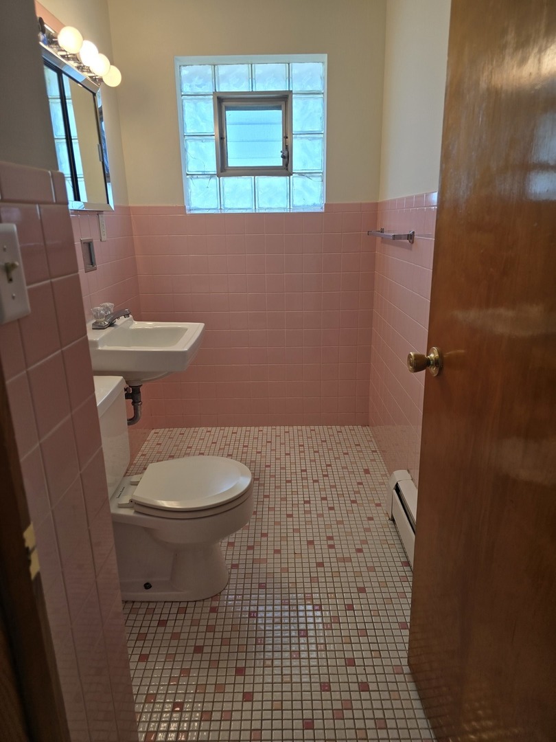 517 Bethel Drive, Unit 2S Joliet, IL 60435 - Photo 9 of 18 a bathroom with a toilet and a shower