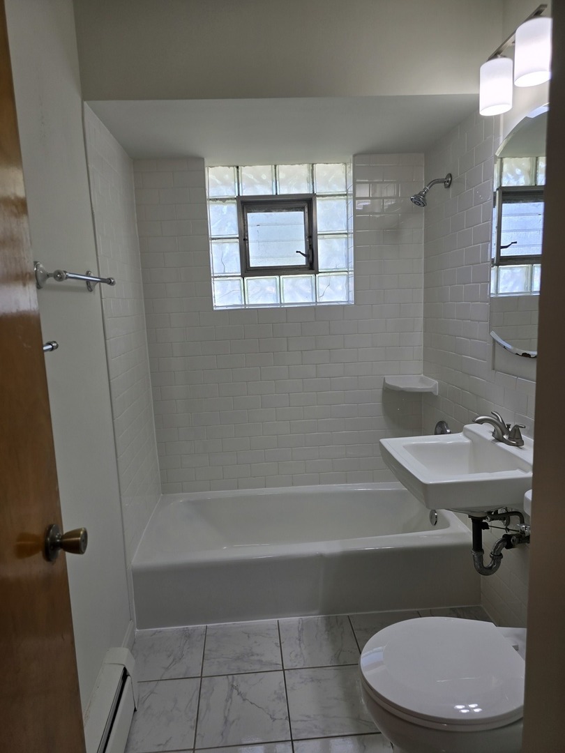517 Bethel Drive, Unit 2S Joliet, IL 60435 - Photo 10 of 18 a bathroom with a sink a toilet and shower