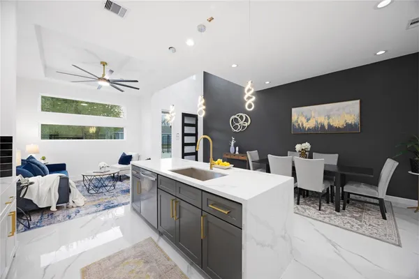 a view of kitchen island with stainless steel appliances refrigerator stove dining table and chairs