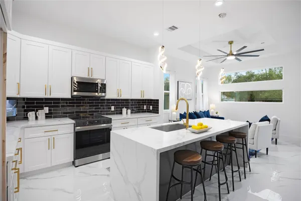 a kitchen with a stove a sink a dining table and chairs