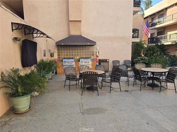 a view of a patio with table and chairs potted plants