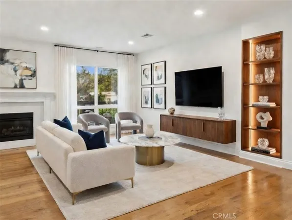 a living room with fireplace furniture and a flat screen tv