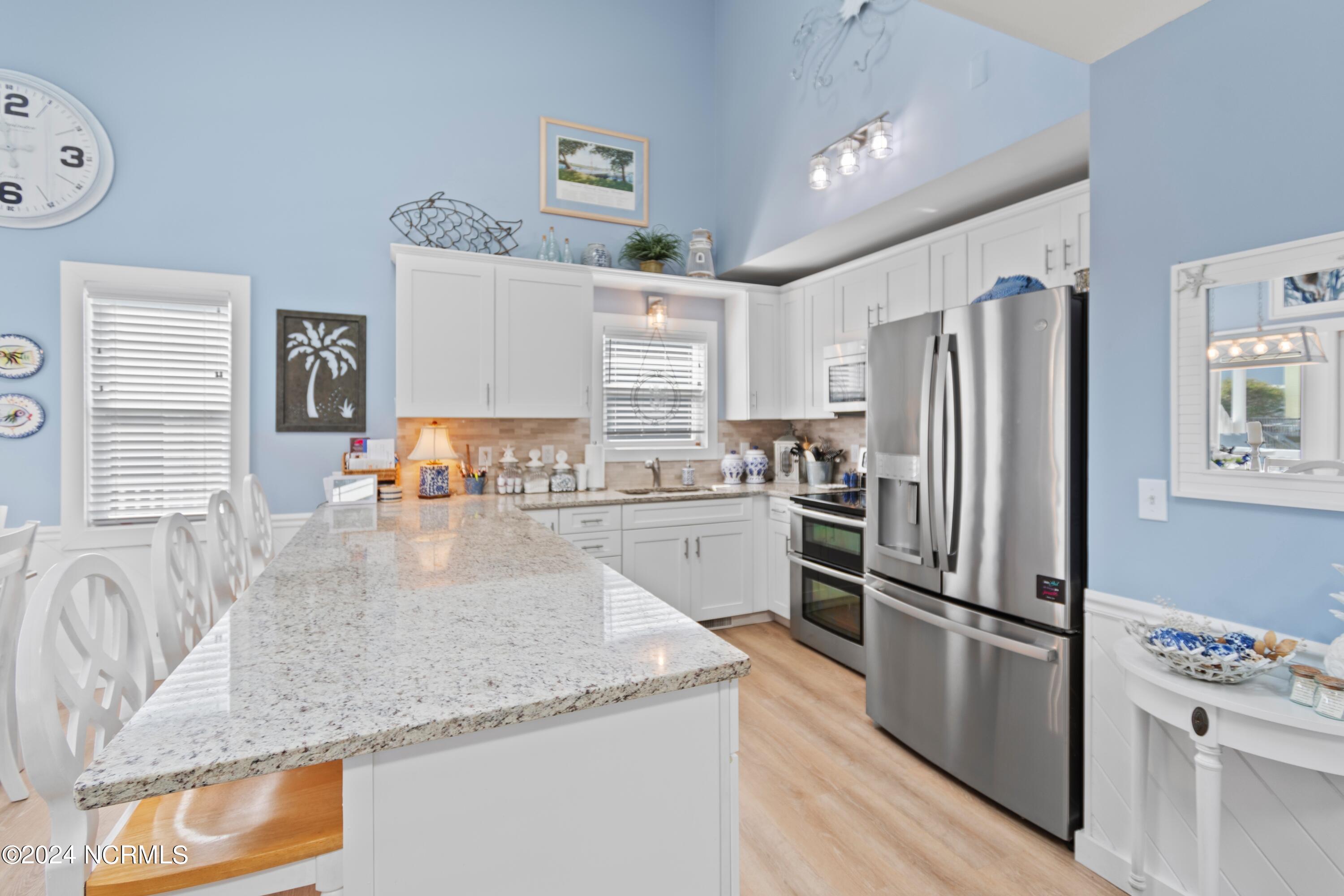 415 Sailfish Street Sunset Beach, NC 28468 - Photo 14 of 63 2021 remodel included kitchen. Granite countertops, lighting, flooring and more.