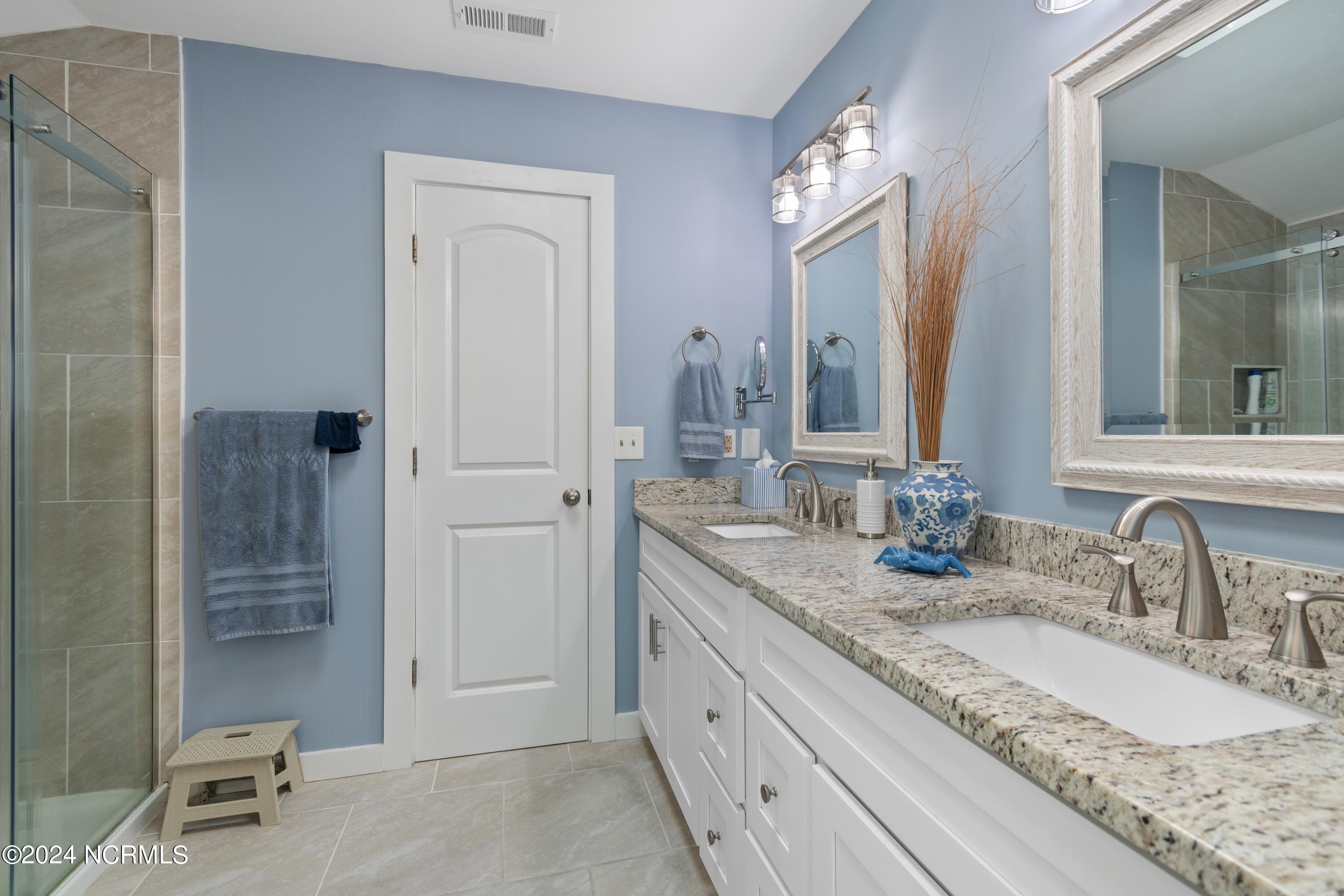 415 Sailfish Street Sunset Beach, NC 28468 - Photo 23 of 63 Bathroom to bedroom #1 (primary bath). Bathrooms remodeled in 2021.